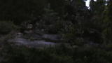 Finding Bigfoot: Bigfoot Squatting Behind Rock